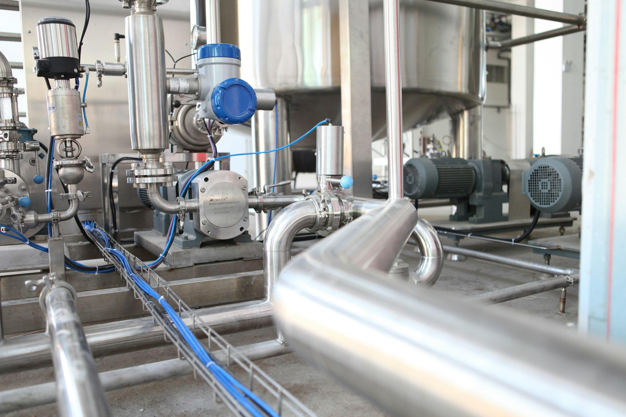 Stainless-steel process skid with pumps, motors, valves and polished pipework